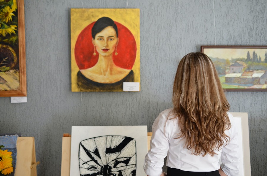 woman-looking-at-paintings-displayed-on-the-wall-2721507.jpg